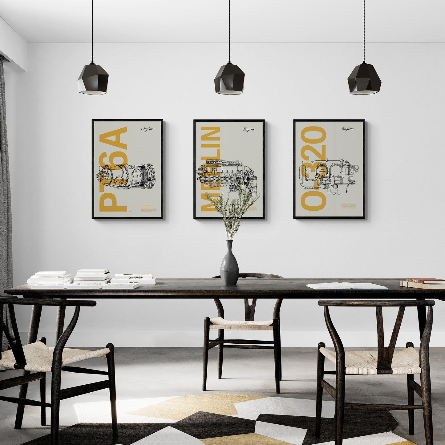 Three framed posters hanging in a modern dining room over a long, black dining table and chairs. Each shows a famous aircraft engines in line drawing style, with the engine name written big in mustard yellow
