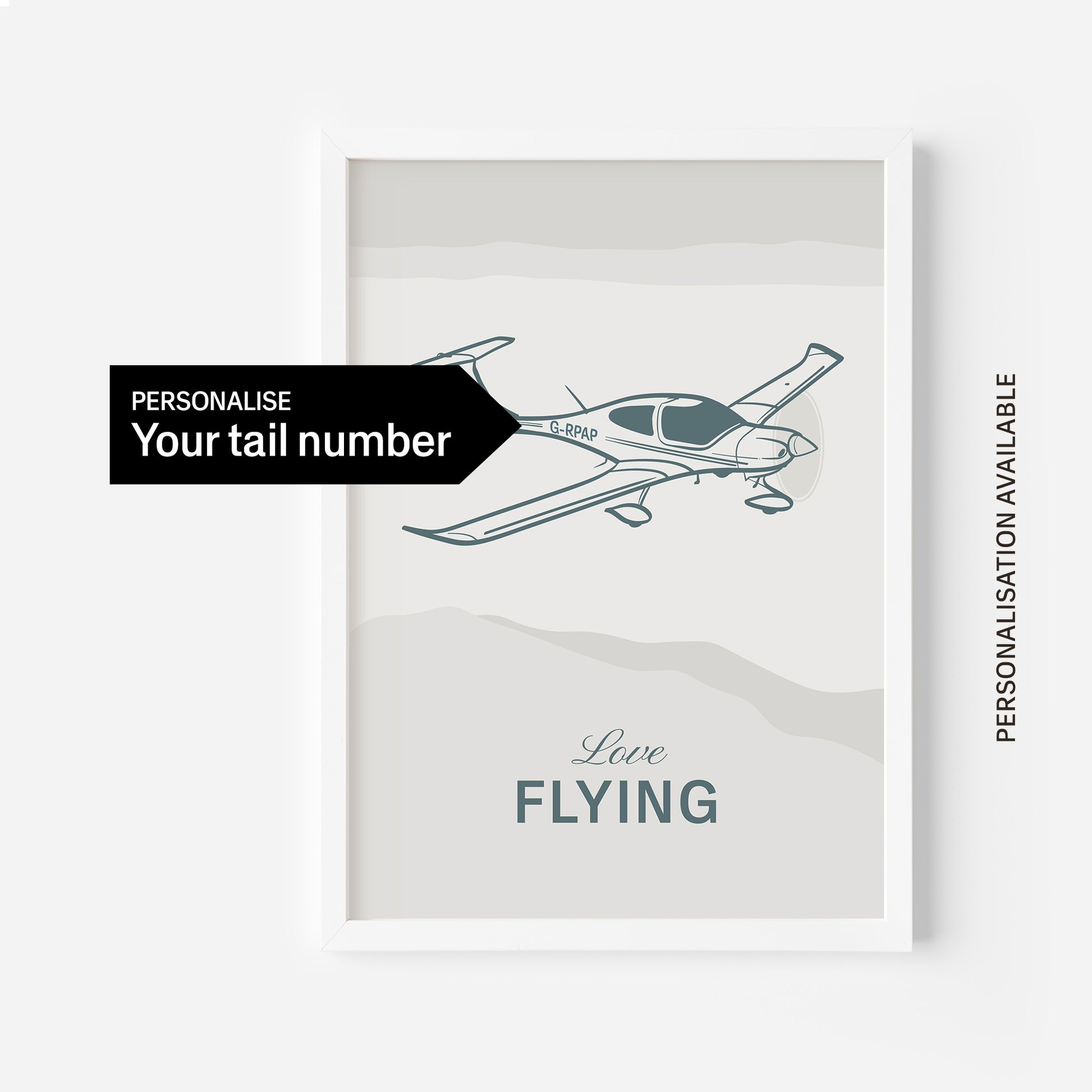 A framed print with and illustration of a light aircraft illustration with the words Love Flying in white over an off white background and a black arrow pointing to the tail with the words personalise your tail number