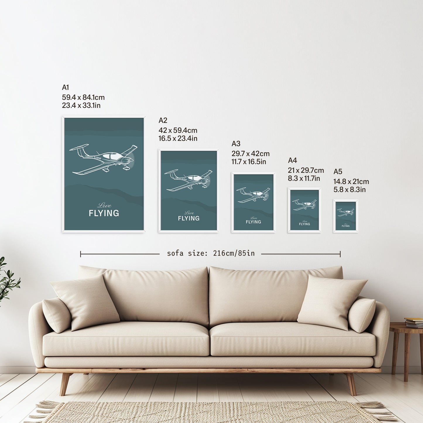 5 framed posters hanging on a white wall above a sofa. They are arranged according to size from A1 down to A5 with the correspondent measurements listed in inches and centimetres next to each