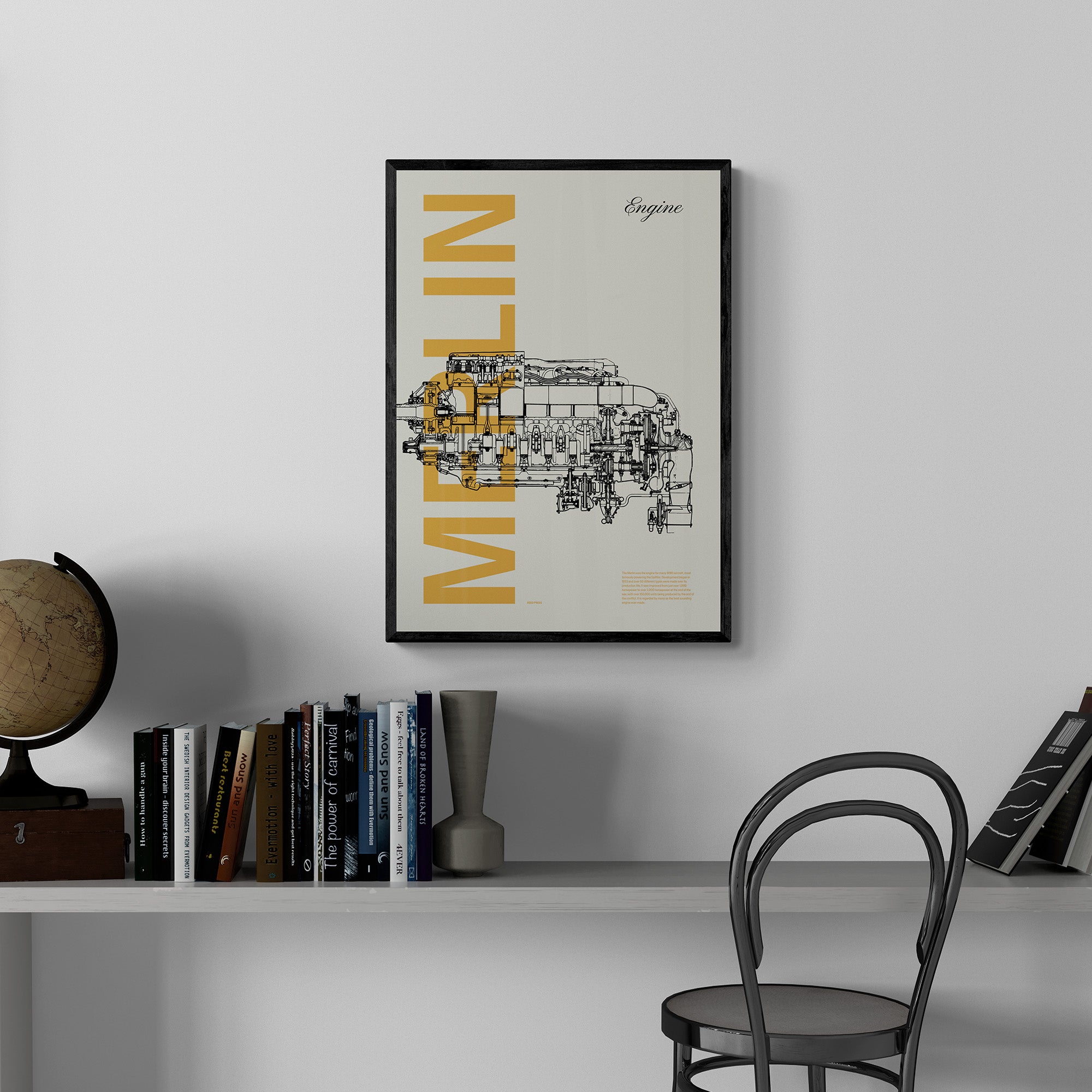 A framed poster hanging in a home, office over a desk and books. It shows a Merlin aircraft engine in line drawing style with the word Merlin written big in mustard yellow