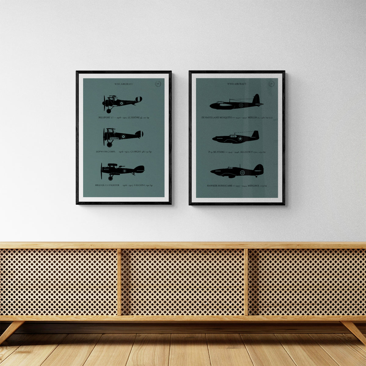 A pair of framed prints hanging over a wooden console table. The first shows three World War one aircraft in silhouette style and the second shows three World War Two aircraft in silhouette style. Both in black over a dark grey background