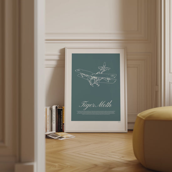 Framed poster displayed in variety of scenes. The poster shows a light aircraft illustration with the words Tiger Moth in white over a teal background